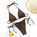 Women's polka dot and floral print split swimsuit bikini set on a mannequin.