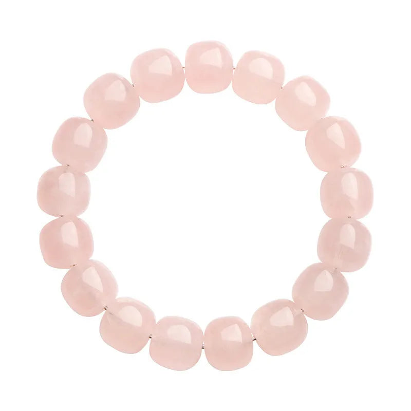 Pink crystal barrel bead bracelet with geometric design on a bamboo string.