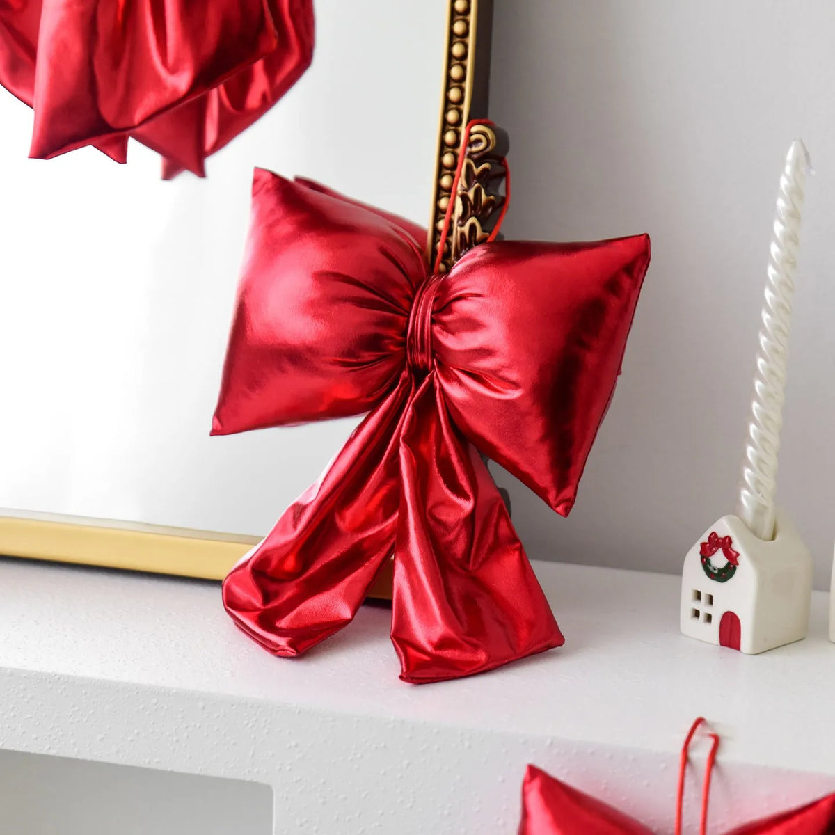 Christmas decorative bowknot with bright leather finish in red colour on a tree branch