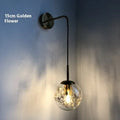 Modern glass wall lamp with LED light in gold or silver finish, shown in 15cm and 20cm sizes.