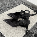 Women's black lace-up high heels with a special-shaped root design on a white background.