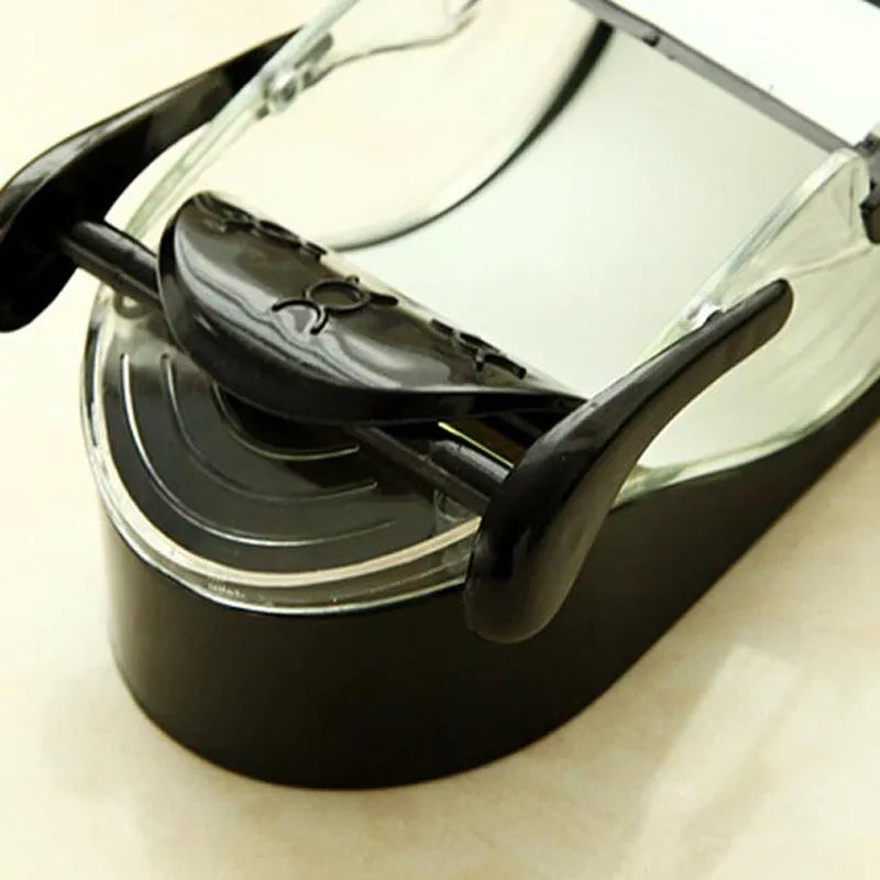 Black DIY plastic kitchen roll sushi machine on a flat surface with lever and roller band visible