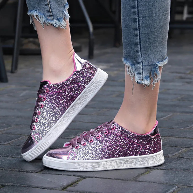 Women's black low-top casual shoes with sparkling sequinned upper and white laces.