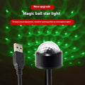 USB car atmosphere projection star light in black ABS plastic plugged into a vehicle interior