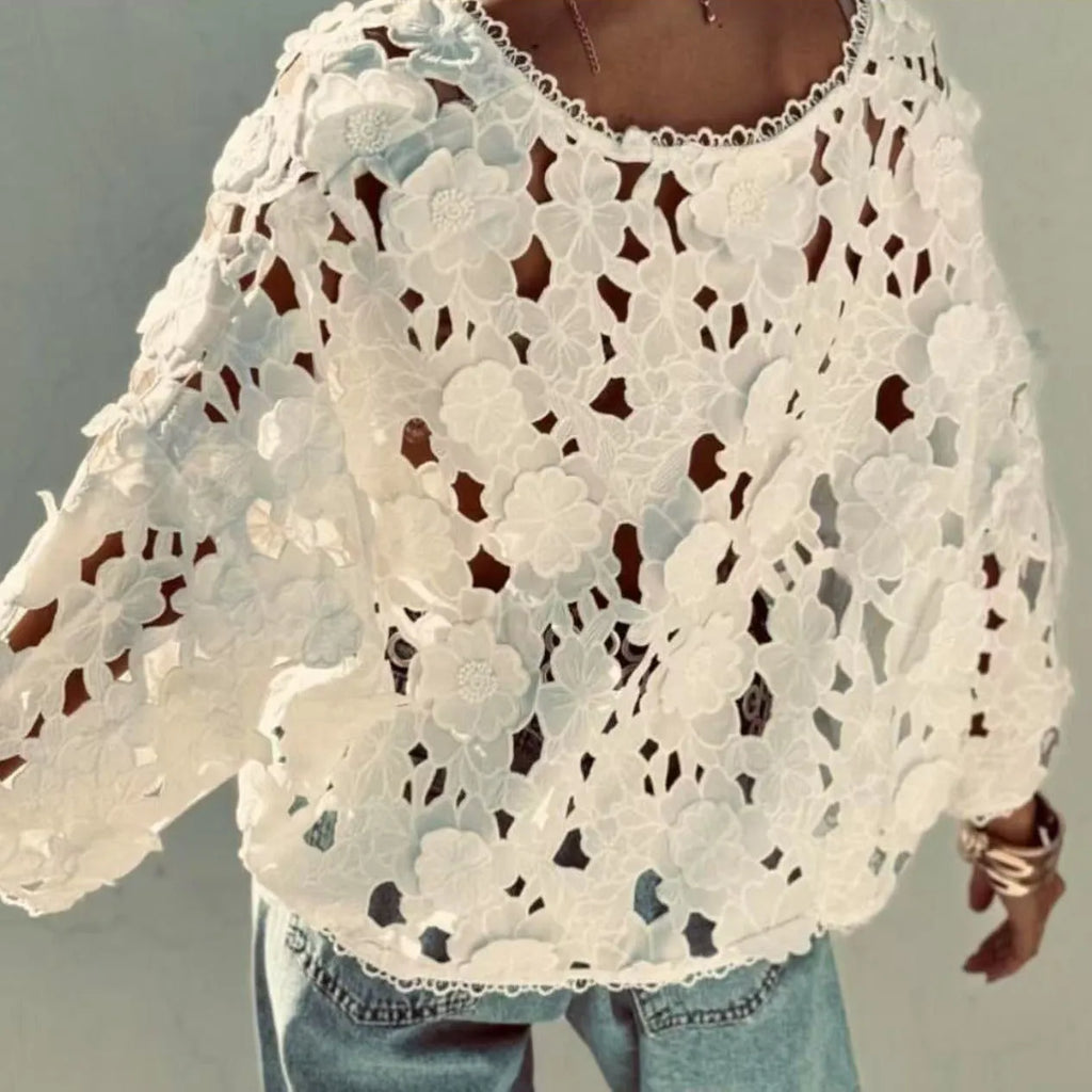 Loose-fit black lace cardigan with 3D flower detailing on a model, showing V-neck and long sleeves.
