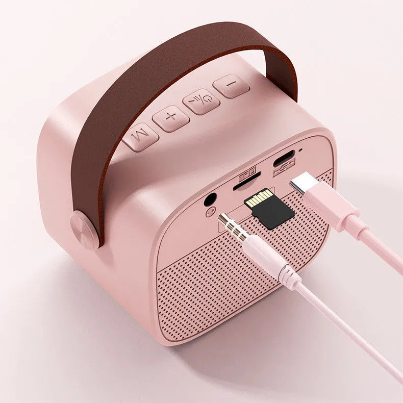 Compact white, pink, or blue wireless Bluetooth portable speaker with built-in microphone