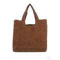 Woven straw bucket tote bag in a neutral colour with double straps and an open outer pocket.