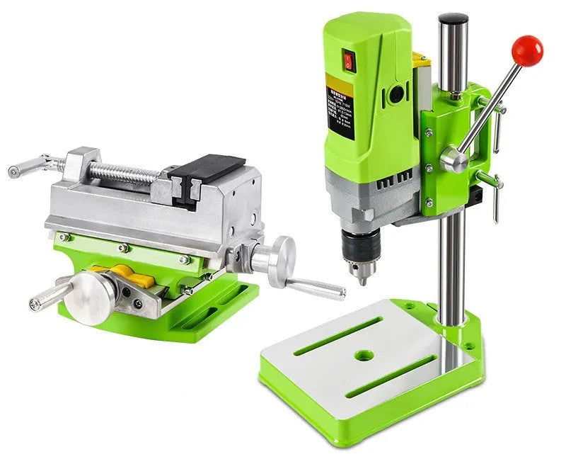 Mini bench drill milling machine on a workbench with optional pliers or drill accessories.