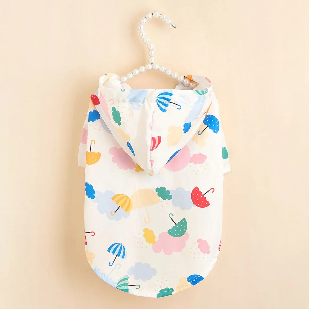 Colourful cartoon umbrella pattern pet raincoat for a small dog, showing the polyester material and size label.