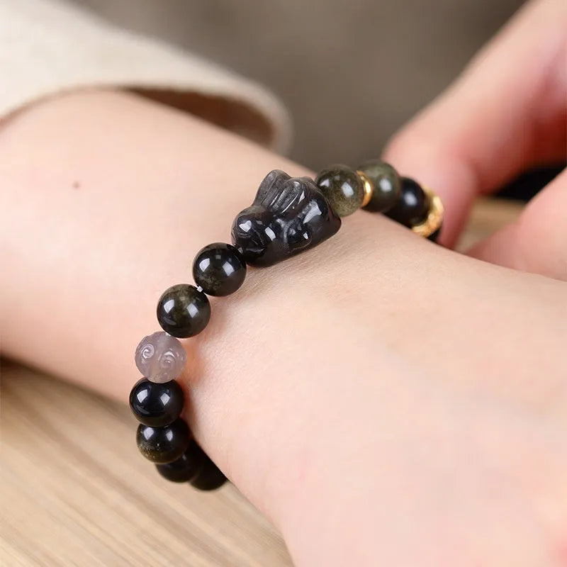 Handmade obsidian bracelet with lying rabbit charm, grey agate accents, and Yaoshi metallic elements in traditional national style