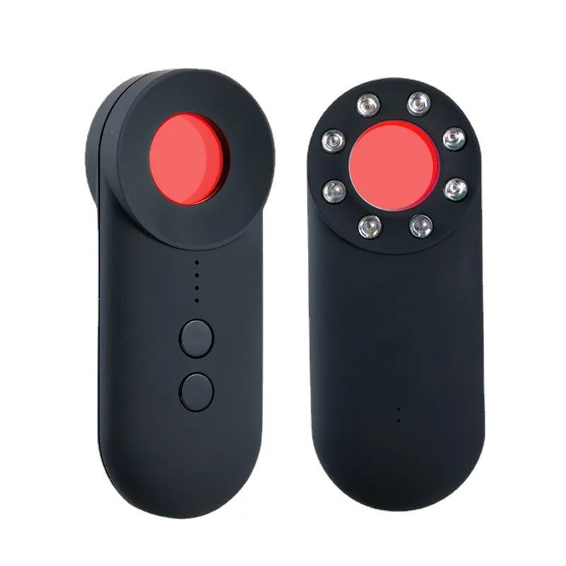 Black portable GPS and hidden camera detector with USB cable on a flat surface.