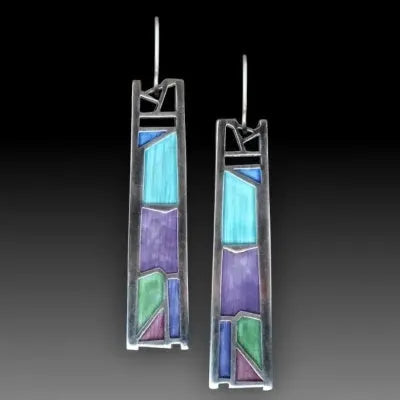 Silver-coloured women's earrings in a water drop shape with an irregular, textured edge design.