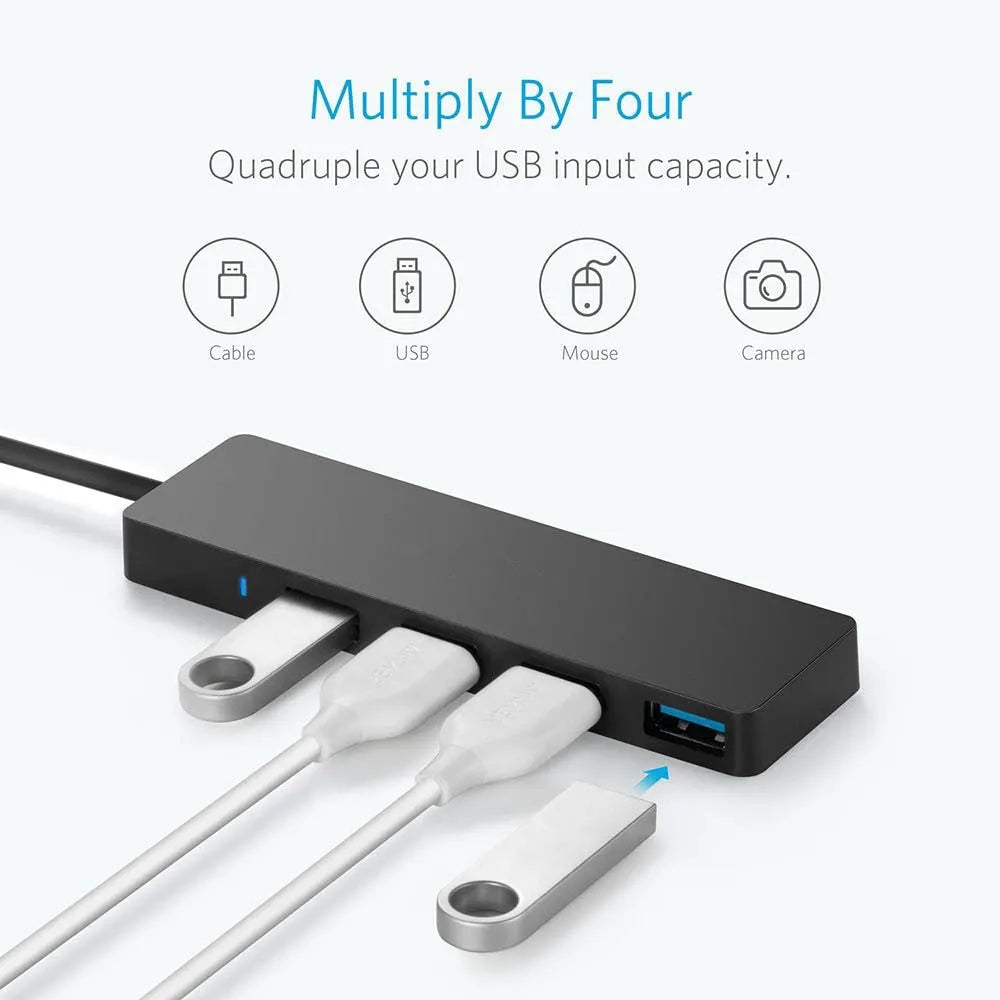 Black USB 3.0 hub with four ports, LED indicators, and a 30 cm attached cable on a desk.