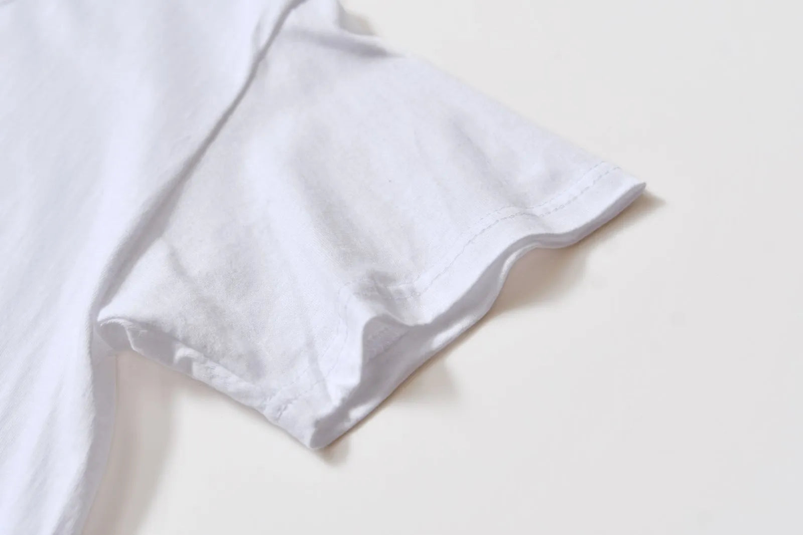 White patterned cotton pullover top with short sleeves on a hanger