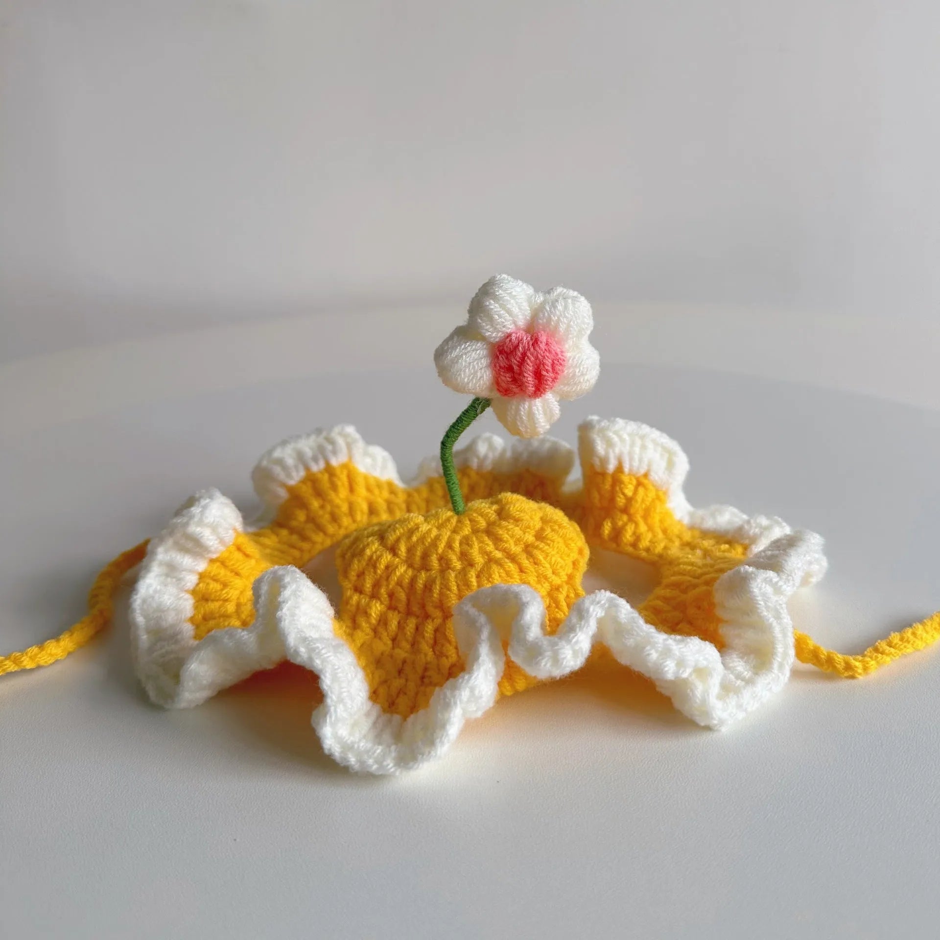 Knitted pet hat with cartoon design for cats and small dogs in green colour