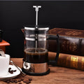 Glass and stainless steel manual coffee maker with 350ml capacity measuring 10cm wide by 8cm deep by 17cm tall