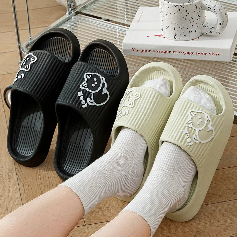 Women's green cat-themed platform slippers with non-slip EVA sole on a wooden floor.