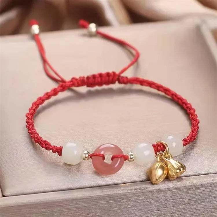 Hetian jade bracelet with constellation design and a brown carrying strap fastened with a Peace Buckle.