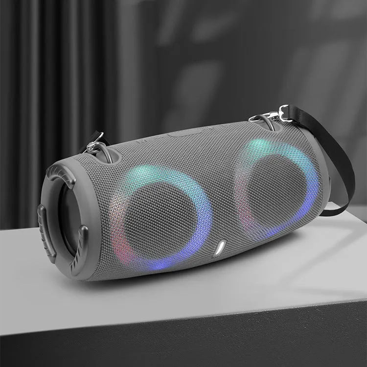 War Drum portable Bluetooth speaker with coloured RGB lights in camouflage colour, showing carrying strap and control buttons.
