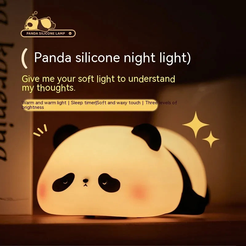 Cartoon panda silicone night light with USB charging cable on wooden surface