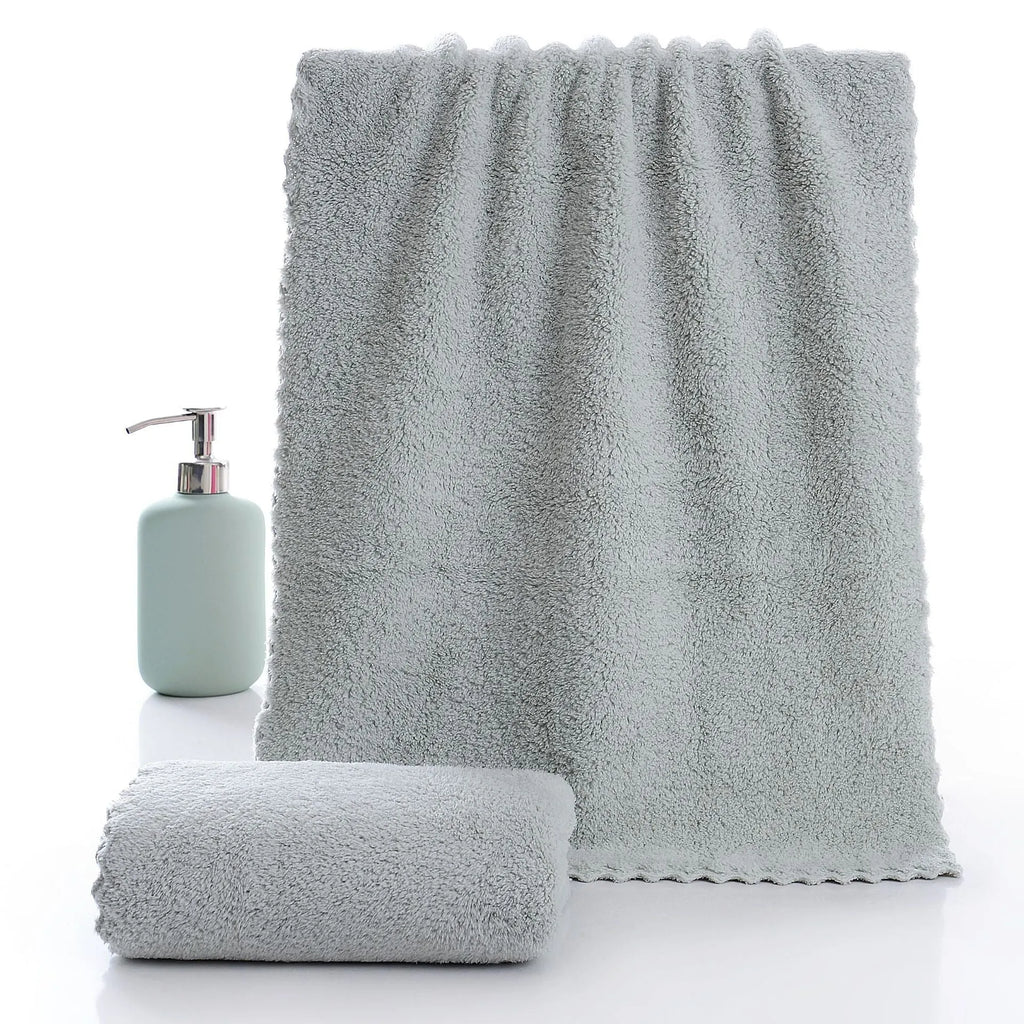Coral fleece absorbent household towel in coral pink colour showing soft textured surface