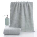 Coral fleece absorbent household towel in coral pink colour showing soft textured surface