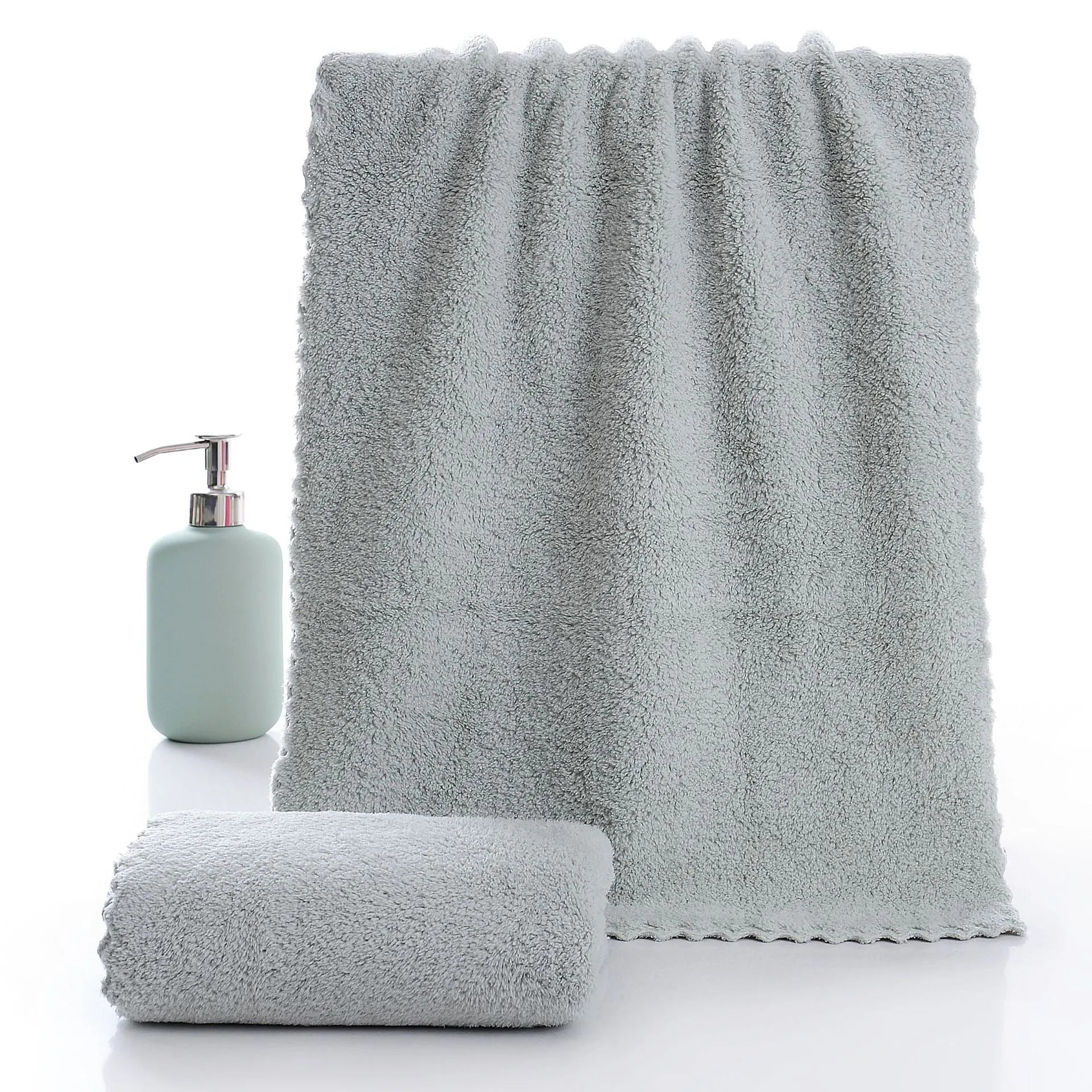 Coral fleece absorbent household towel in coral pink colour showing soft textured surface