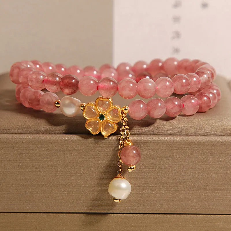Women's twin four-leaf clover charm bracelet with strawberry quartz crystals and alloy inlay settings.
