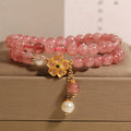 Women's twin four-leaf clover charm bracelet with strawberry quartz crystals and alloy inlay settings.