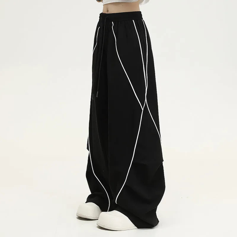Black pleated wide-leg hip hop sports trousers with striped pattern on a mid waist.