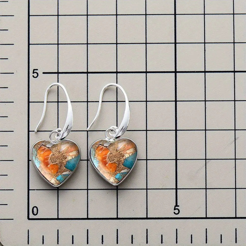 Silver alloy vintage bohemian water droplet pendant drop earrings on light background