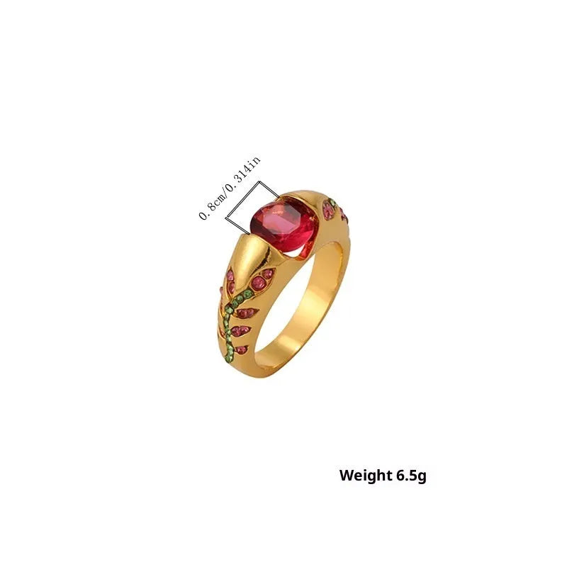 Leaf style zinc alloy ring with round zirconium inlay in gold colour on white background