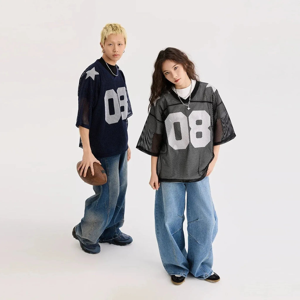 Loose fit black pullover shirt with white letters pattern print, short sleeves, on a hanger.