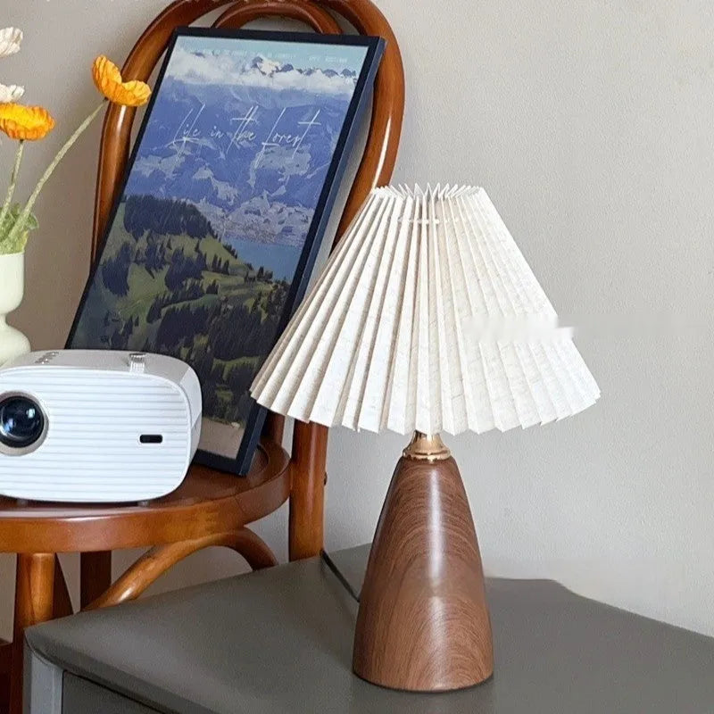 Nordic retro ceramic table lamp with a pleated tapered floral shade on a bedside table.