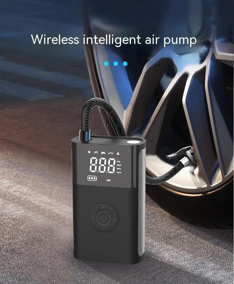 Black handheld wireless digital tyre inflator with LCD screen, showing pressure reading, with accessory nozzles
