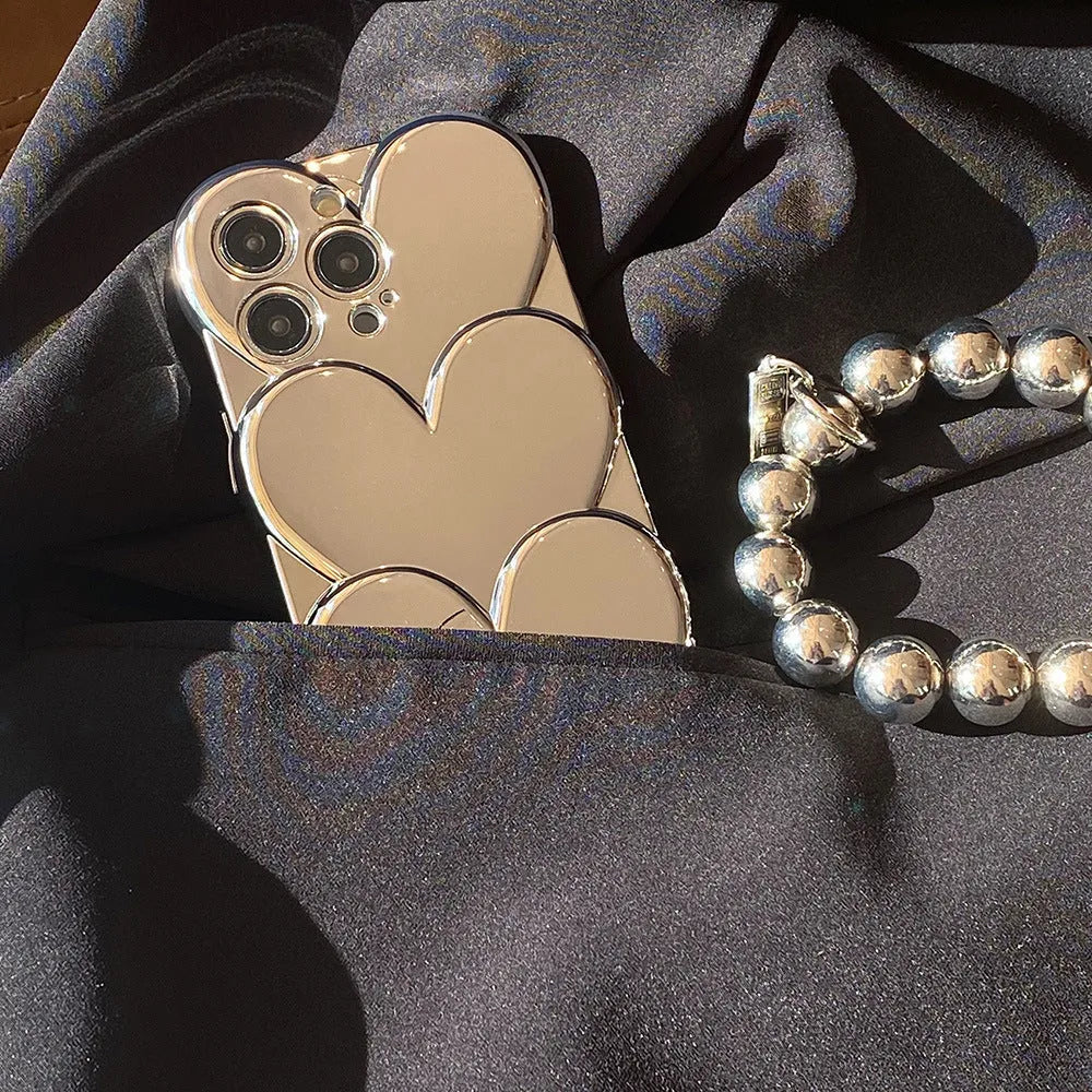 Soft TPU iPhone case with shiny 3D electroplating love design, shown next to matching bracelet.