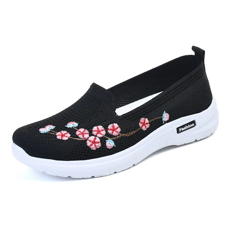 Women's wine red embroidered low heel pumps with round toe and anti-slip sole.