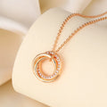 Geometric copper necklace with micro-inlaid interlocking three rings in champagne gold on woman