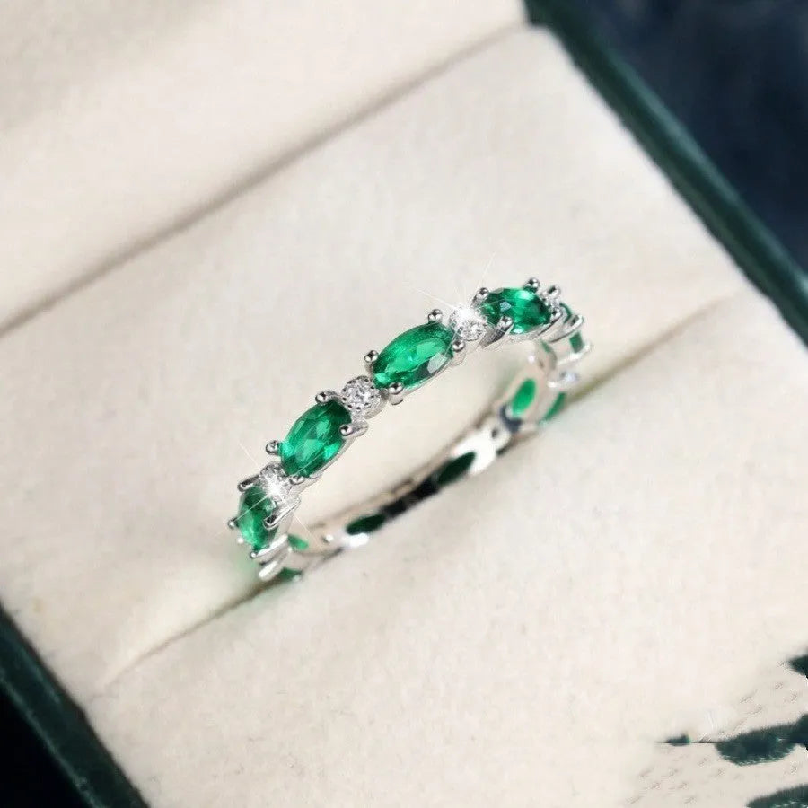 Copper ring with green and white zircon inlay geometric design on finger