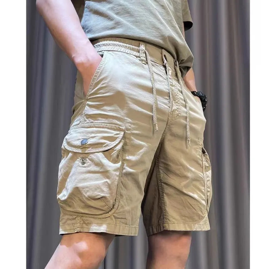 Korean style loose straight leg overalls trousers in khaki with multiple pockets, shown on a model.