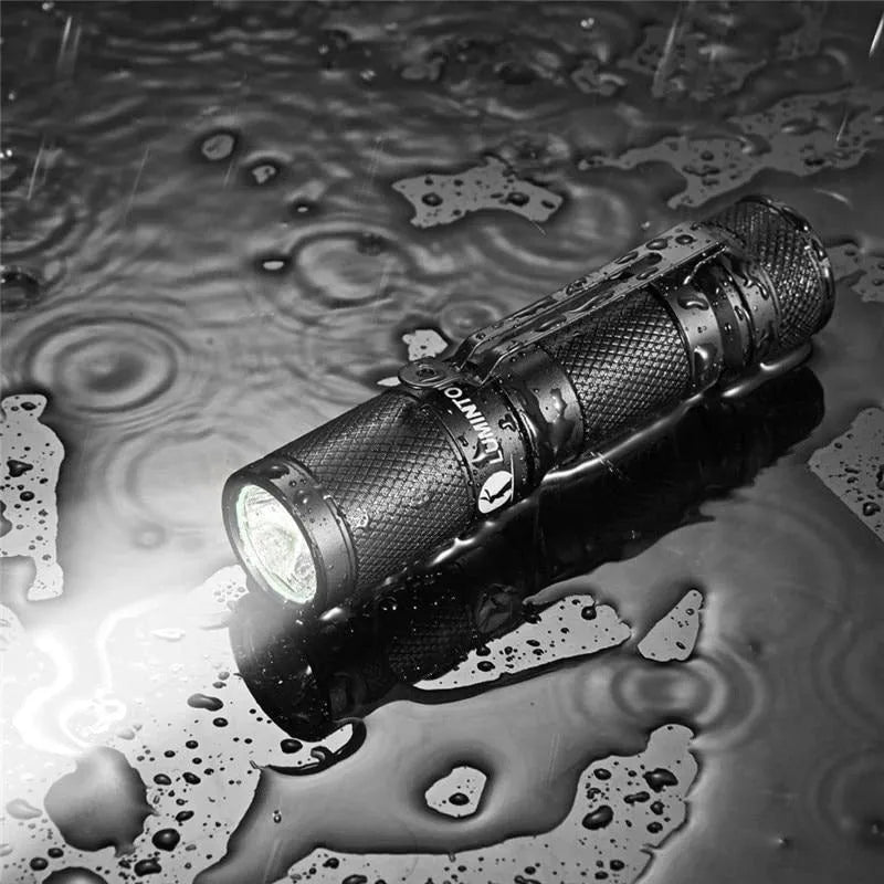 Black Lumintop Tool AA 2.0 compact keychain flashlight with magnetic tail cap on a keyring.