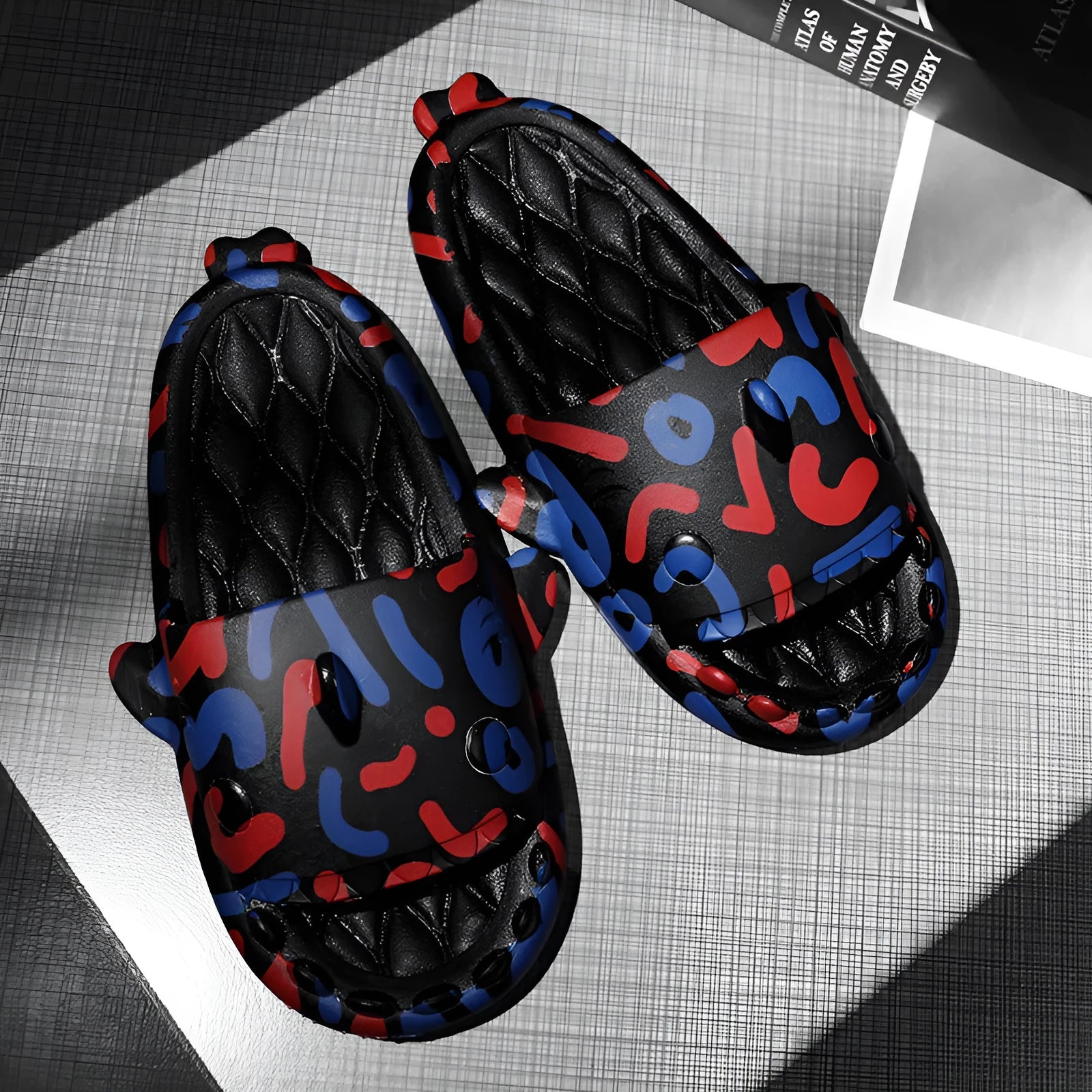Pair of grey EVA foam open-toe slippers with a raised shark fin design on the front.