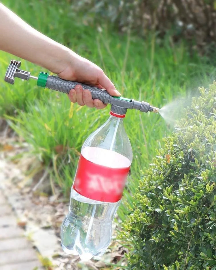 Grey watering sprayer nozzle attached to plastic bottle with 30cm connecting tube for garden watering