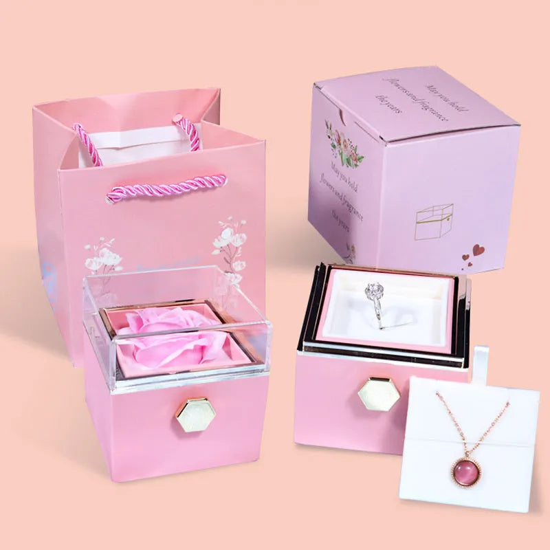 Rotating drawer jewellery gift box with preserved red rose under clear acrylic dome.