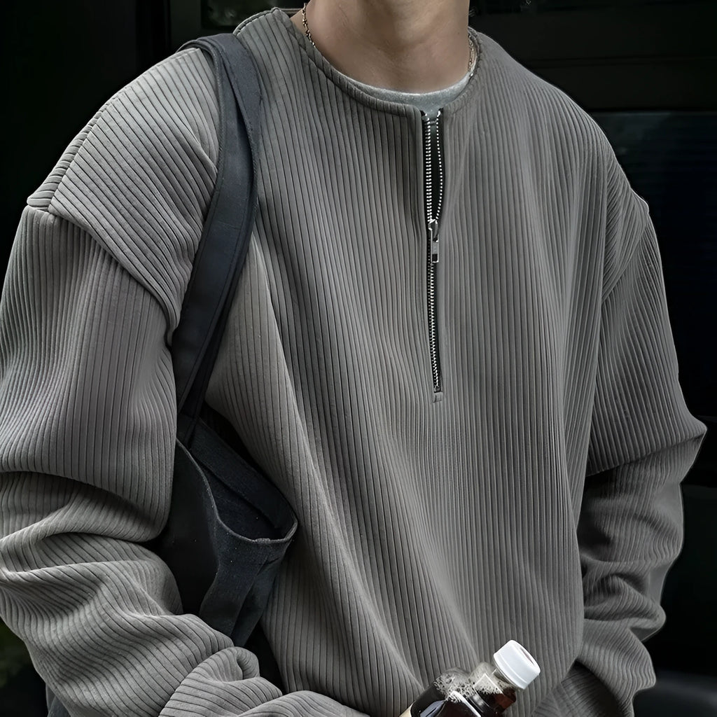 A solid colour loose pullover top for women in grey, shown as a layering piece.