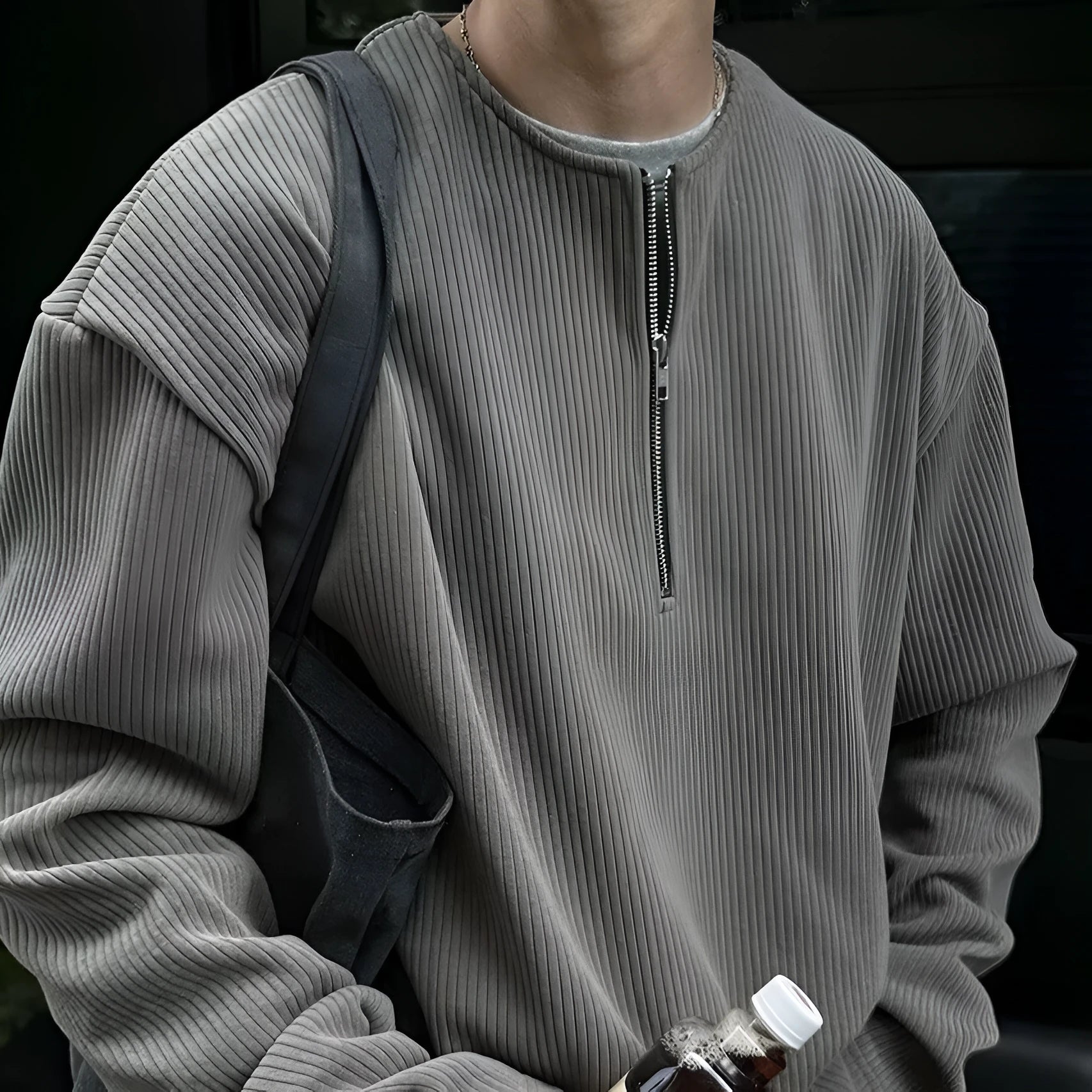 A solid colour loose pullover top for women in grey, shown as a layering piece.