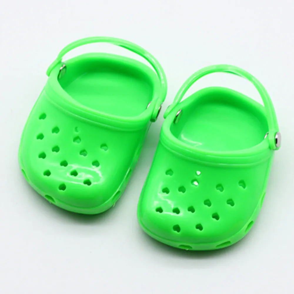 Set of small plastic doll beach slippers in blue, red, yellow, and green colours.