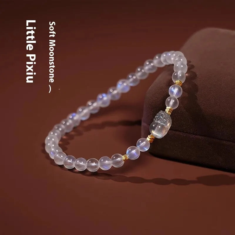 Polished moonstone bracelet with animal/Zodiac design on an adjustable cord for women.
