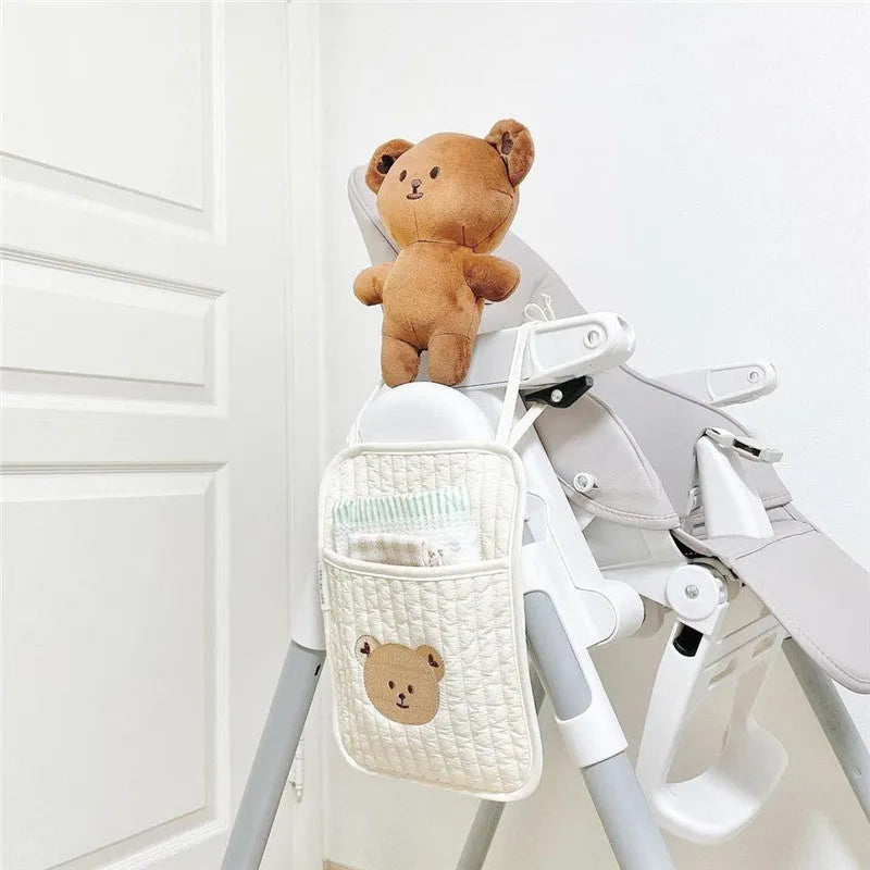 Cotton cloth hanging storage bag for baby bottles and diapers, available in six colours including bear, olive, and tulip