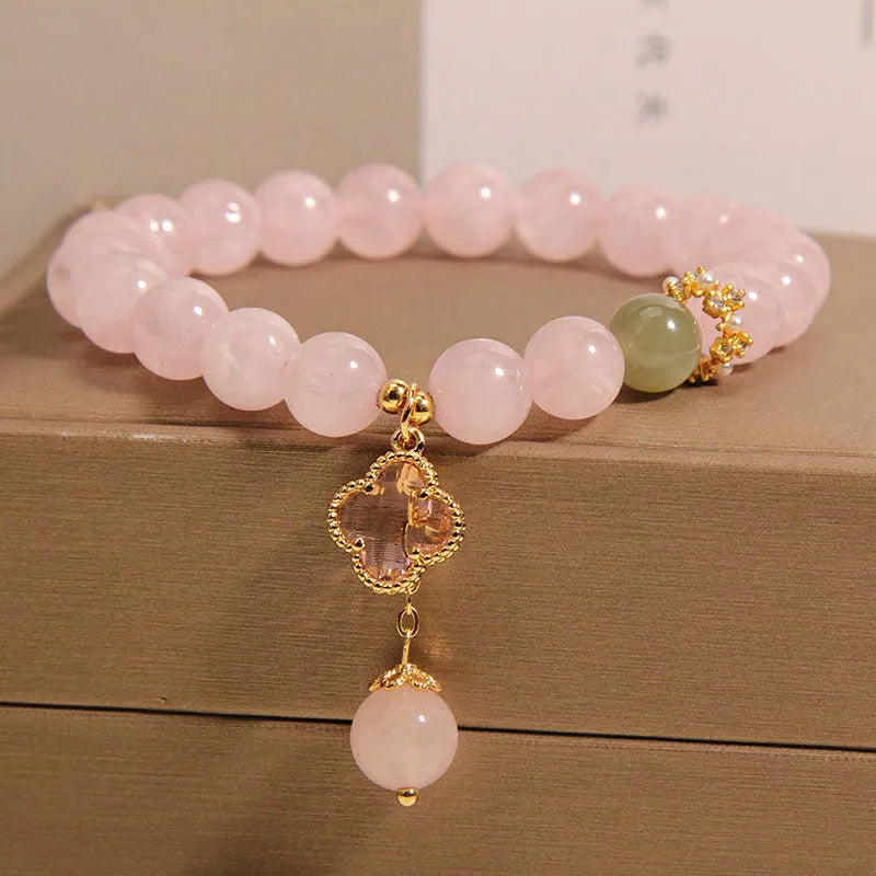 Pink crystal bracelet for women with a four-leaf clover pendant, alloy inlay, and rhinestones.
